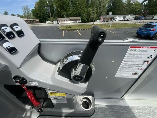 Slide: The Image of 2024 Harris 230CX boat throttle control with safety instructions and parking lot view. - 4