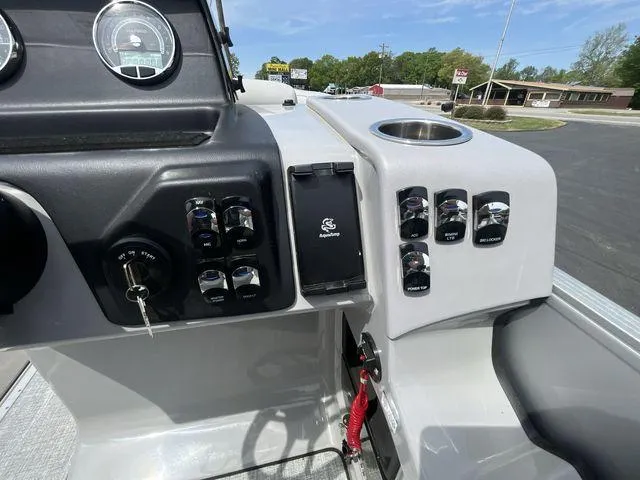 Slide: The Image of 2024 Harris 230CX boat dashboard with controls and gauges, featuring a sleek design. - 6