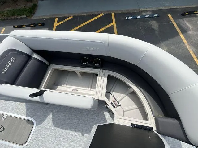 Slide: The Image of 2024 Harris 230CX boat interior with storage and cup holders. - 9