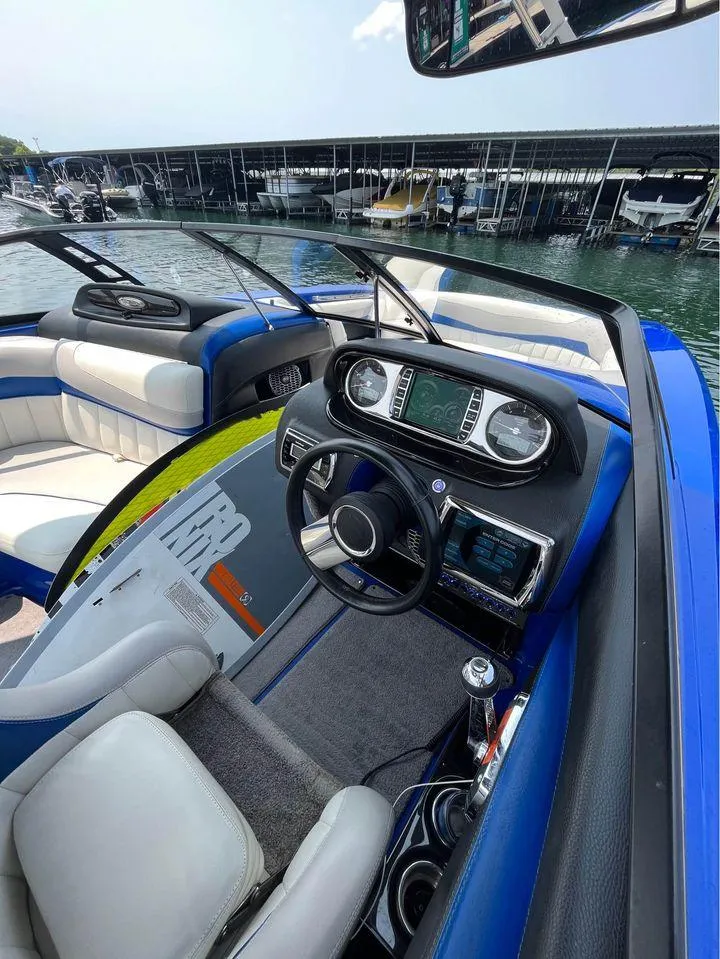 Slide: The Image of Interior of 2012 Malibu 22 MXZ boat with modern dashboard and seating. - 4