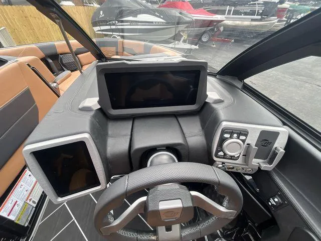 Slide: The Image of 2024 Malibu 23LSV boat dashboard with modern controls and touchscreen displays. - 4