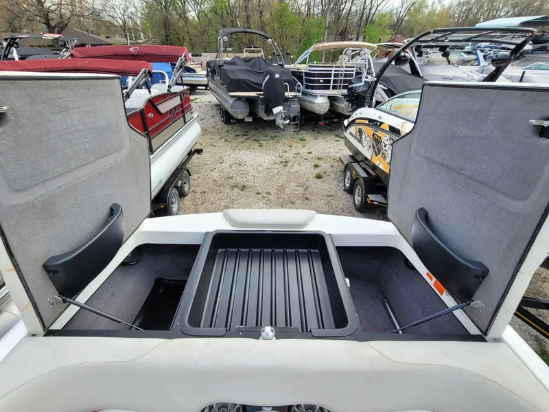 Slide: The Image of 2007 Malibu 247 Wakesetter boat storage compartment open, surrounded by other boats. - 12