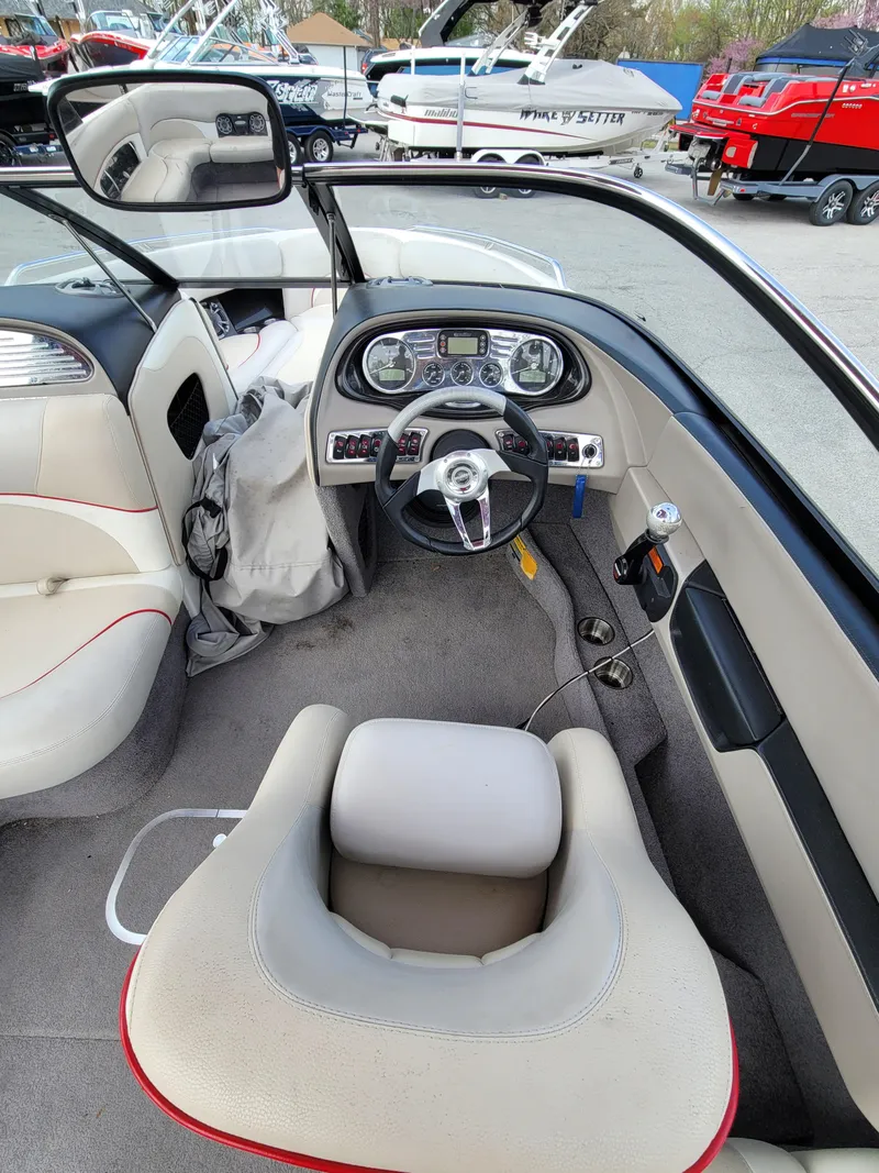 Slide: The Image of 2007 Malibu 247 Wakesetter boat interior with steering wheel and dashboard controls. - 3