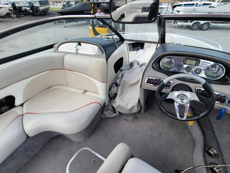 Slide: The Image of 2007 Malibu 247 Wakesetter boat interior with steering wheel and seating area. - 4