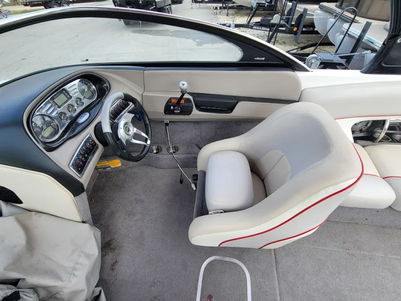 Slide: The Image of 2007 Malibu 247 Wakesetter boat interior with steering wheel and dashboard controls. - 5