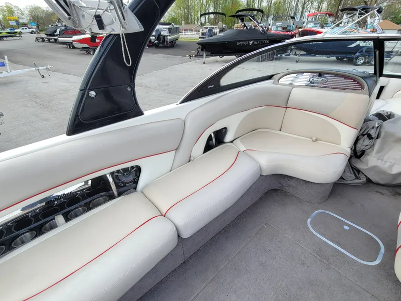 Slide: The Image of 2007 Malibu 247 Wakesetter interior with white seating and red accents. - 9