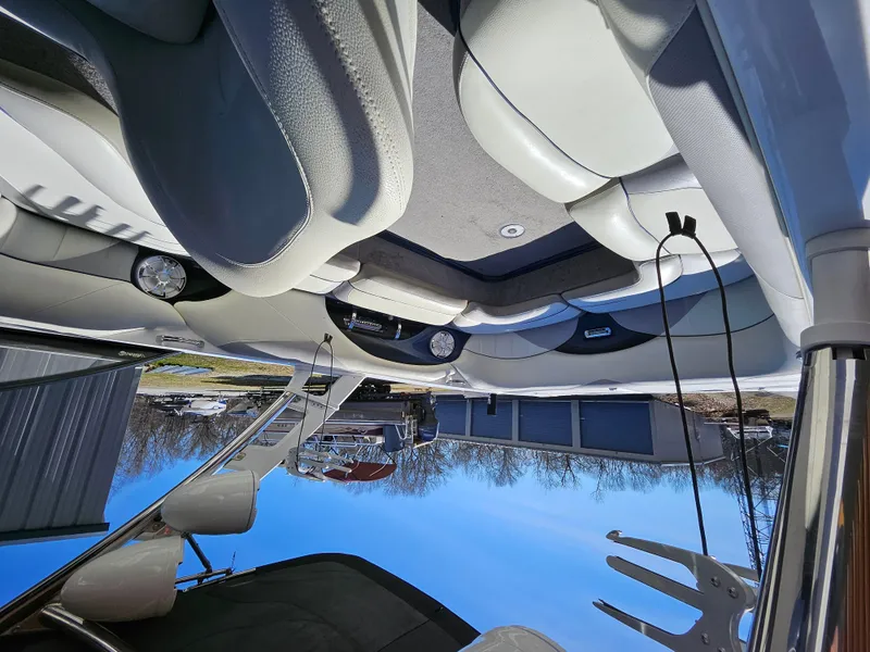 Slide: The Image of Interior of a 2011 Malibu W247LSV boat with white seating and speakers. - 5