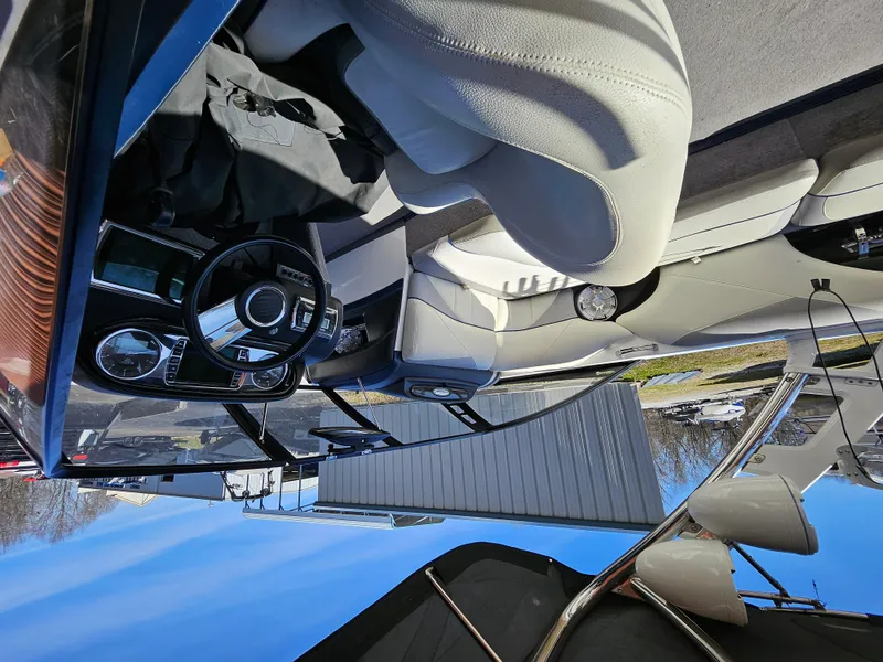 Slide: The Image of Interior of a 2011 Malibu W247LSV boat with white leather seats and steering wheel. - 6