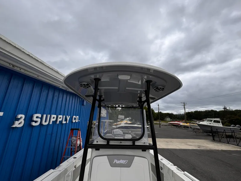 Slide: The Image of 2025 Parker 23SE Center Console boat at a supply company, overcast sky. - 11