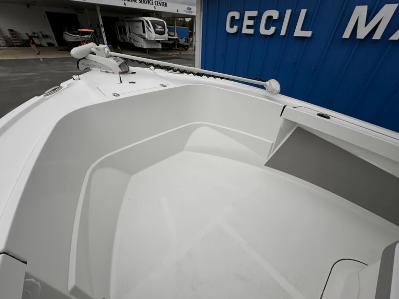 Slide: The Image of 2025 Parker 23SE Center Console boat, bow view, near marine service center. - 14