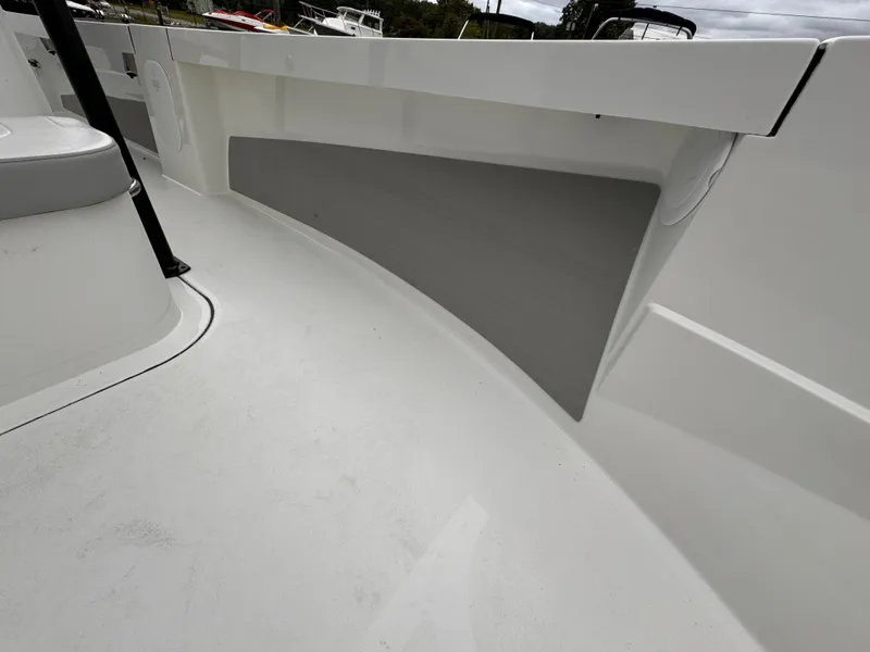 Slide: The Image of 2025 Parker 23SE Center Console boat interior, featuring sleek white deck and seating. - 16