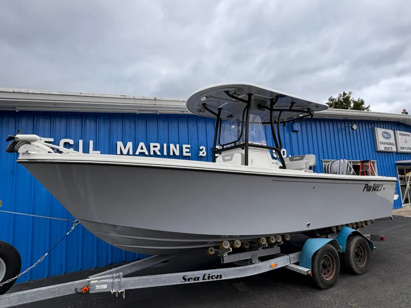 Slide: The Image of 2025 Parker 23SE Center Console boat on trailer outside marine shop. - 2