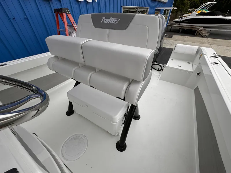 Slide: The Image of 2025 Parker 23SE Center Console boat with cushioned seating and storage. - 20