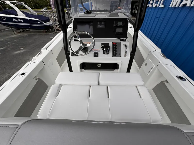 Slide: The Image of 2025 Parker 23SE Center Console boat interior with steering wheel and seating. - 25