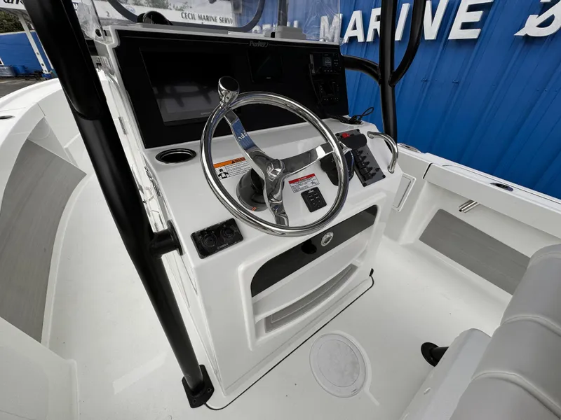 Slide: The Image of 2025 Parker 23SE Center Console boat interior with steering wheel and controls. - 27