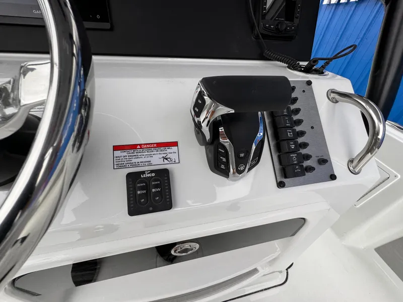 Slide: The Image of Center console controls of 2025 Parker 23SE boat, featuring throttle and switch panel. - 28