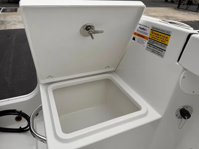 Slide: The Image of Open storage compartment on 2025 Parker 23SE Center Console boat. - 30