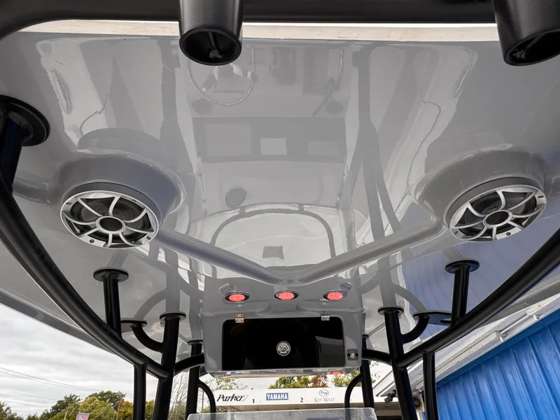 Slide: The Image of 2025 Parker 23SE Center Console boat with speakers and rod holders on the T-top. - 32