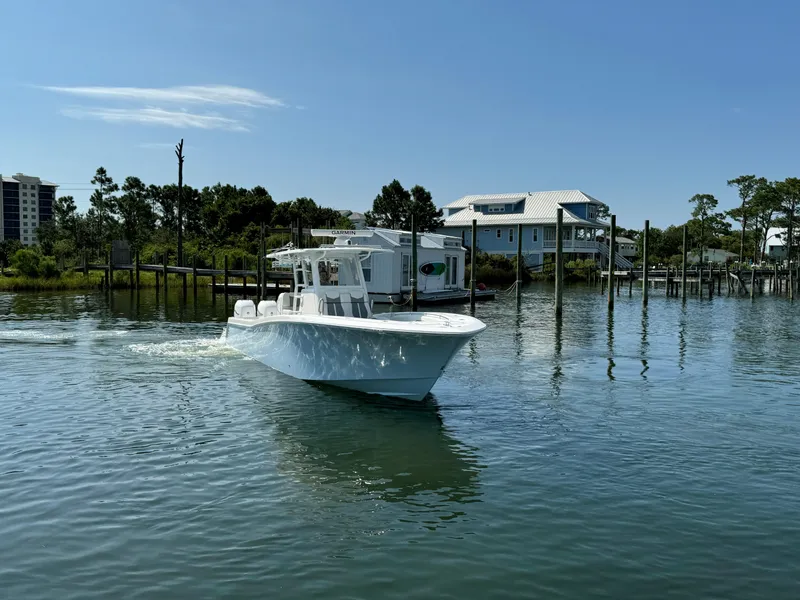 Slide: The Image of 2023 Invincible 36 Open Fisherman boat cruising on a calm waterway. - 11
