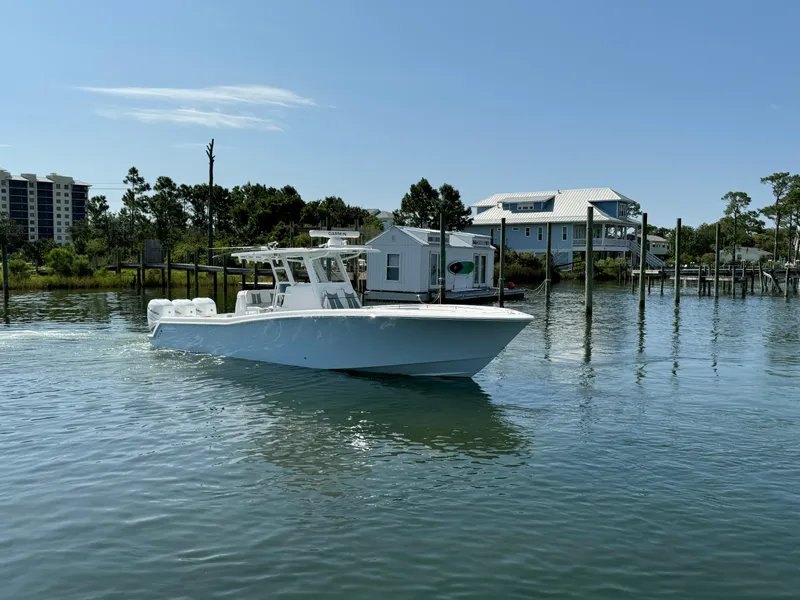 Slide: The Image of 2023 Invincible 36 Open Fisherman boat on calm water near docks. - 12