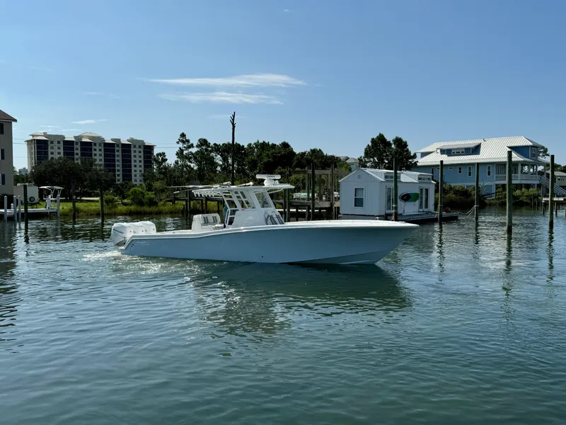 Slide: The Image of 2023 Invincible 36 Open Fisherman boat on calm water near docks. - 13