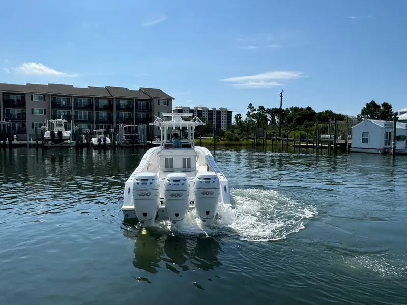 Slide: The Image of 2023 Invincible 36 Open Fisherman boat with triple engines on a calm waterfront. - 20