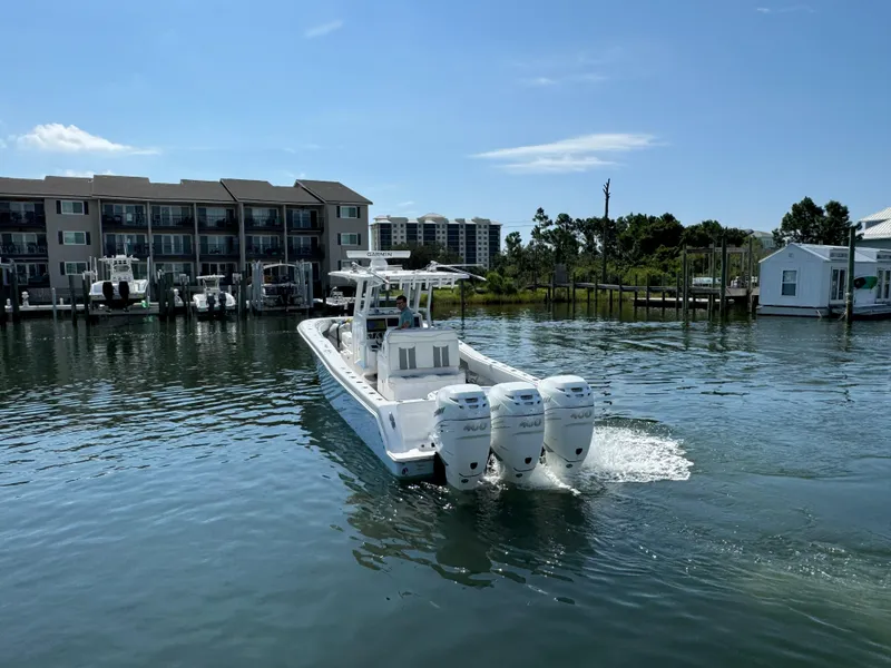 Slide: The Image of 2023 Invincible 36 Open Fisherman boat on calm water near docks. - 22