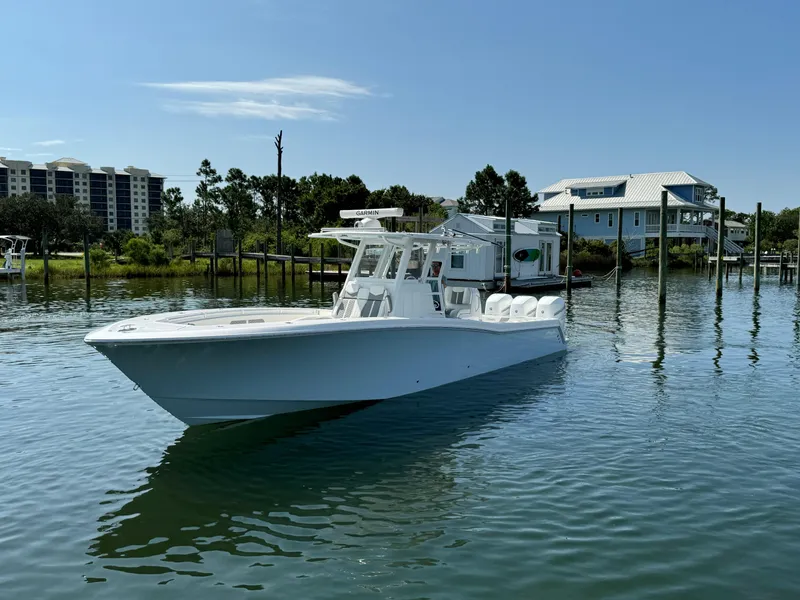Slide: The Image of 2023 Invincible 36 Open Fisherman boat on calm water near docks. - 5