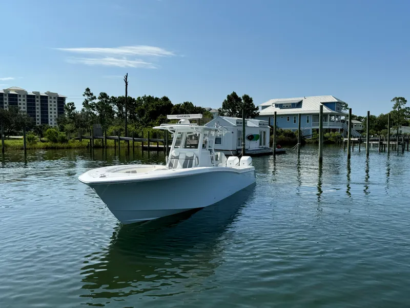 Slide: The Image of 2023 Invincible 36 Open Fisherman boat on calm water near docks. - 6