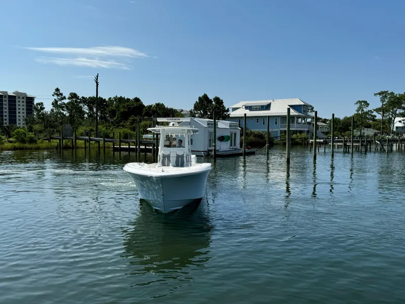 Slide: The Image of 2023 Invincible 36 Open Fisherman boat on calm water near docks. - 8