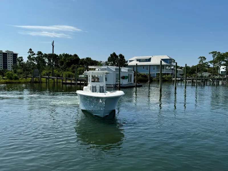 Slide: The Image of 2023 Invincible 36 Open Fisherman boat cruising in a serene waterfront setting. - 9