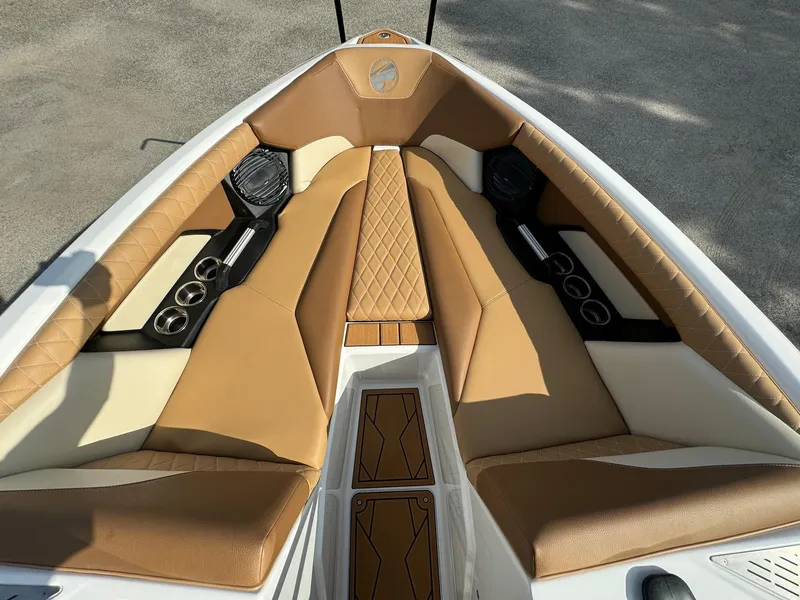 Slide: The Image of 2025 Tigé Z5 boat interior with tan leather seating and modern audio system. - 12