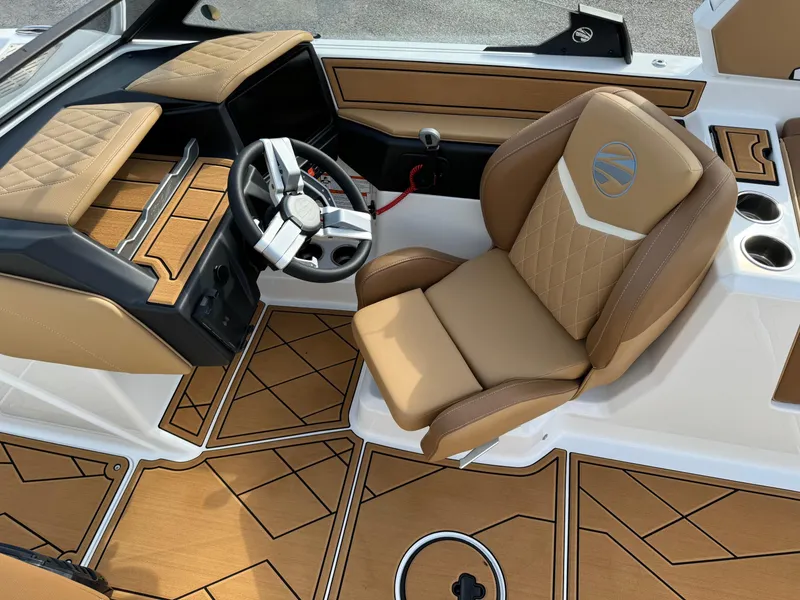 Slide: The Image of 2025 Tigé Z5 boat interior with tan leather seats and modern dashboard. - 8