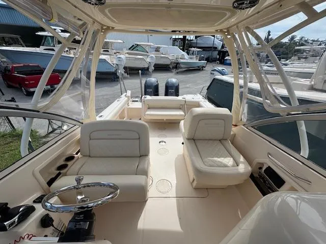 Slide: The Image of 2022 Grady-White Freedom 255 boat interior with dual engines and comfortable seating. - 11