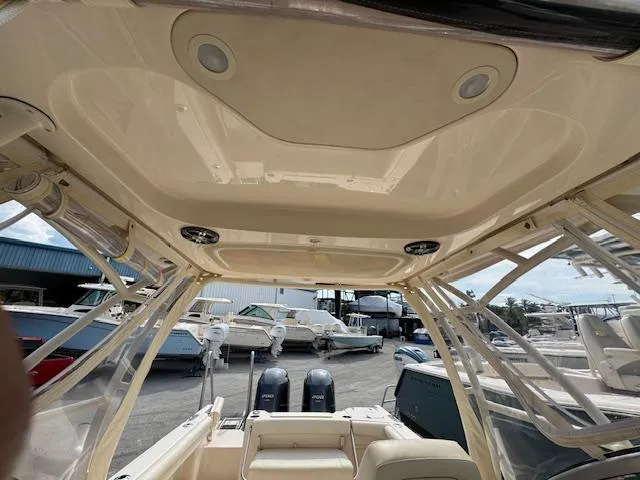 Slide: The Image of 2022 Grady-White Freedom 255 boat interior with dual engines and spacious seating. - 12