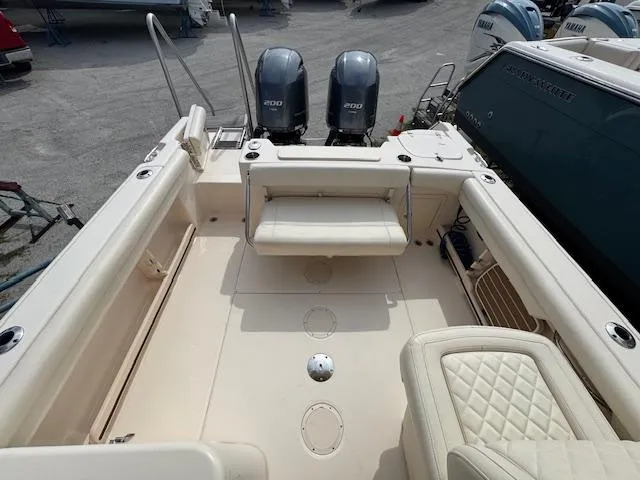 Slide: The Image of 2022 Grady-White Freedom 255 boat interior with twin engines and seating area. - 14