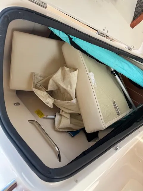 Slide: The Image of 2022 Grady-White Freedom 255 boat storage compartment with cushions and cover. - 9
