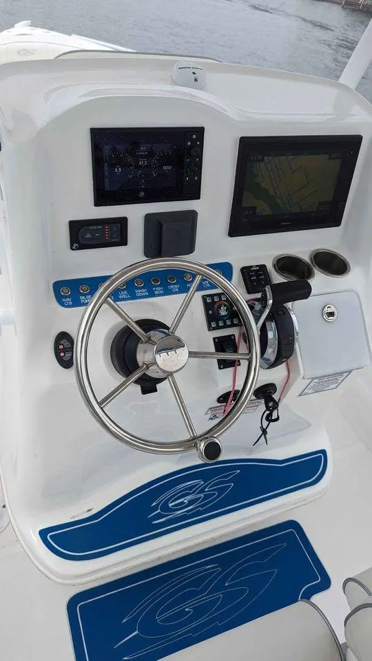 Slide: The Image of 2022 Glasstream 280 Pro-XS boat dashboard with steering wheel and navigation screens. - 7