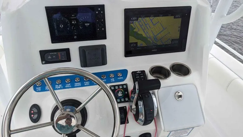 Slide: The Image of 2022 Glasstream 280 Pro-XS boat dashboard with steering wheel and navigation screens. - 8
