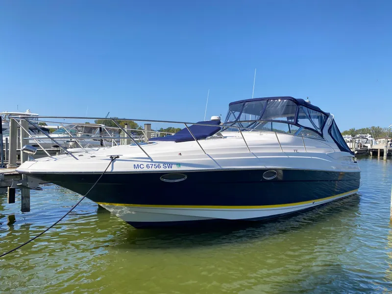 The Image of 2006 Regal 3560 Commodore boat docked in marina under clear blue sky. - 0
