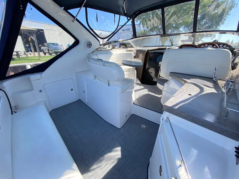 Slide: The Image of 2006 Regal 3560 Commodore boat interior with white seating and modern dashboard. - 1