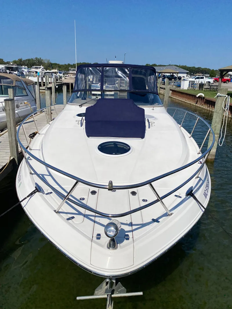 Slide: The Image of 2006 Regal 3560 Commodore yacht docked at marina under clear blue sky. - 10