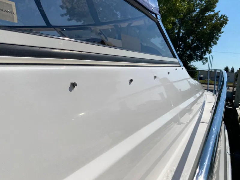 Slide: The Image of 2006 Regal 3560 Commodore boat, sleek white exterior, close-up view. - 13