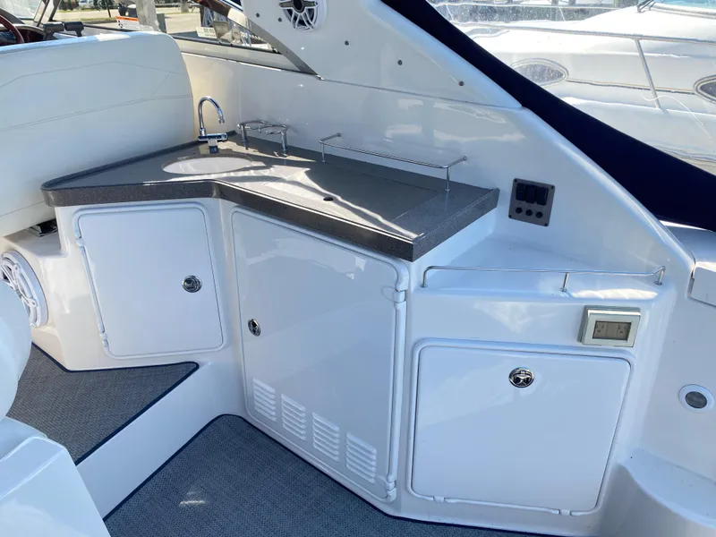 Slide: The Image of 2006 Regal 3560 Commodore yacht interior with sleek kitchenette and modern amenities. - 17