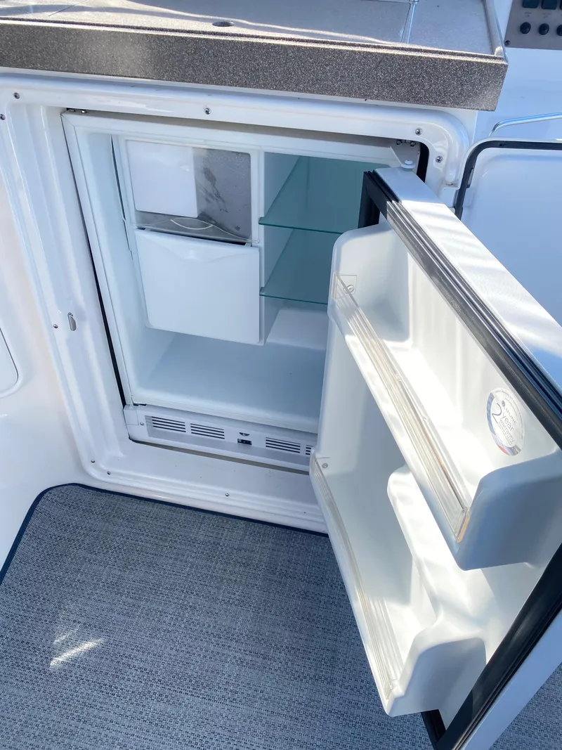 Slide: The Image of Open refrigerator on 2006 Regal 3560 Commodore yacht, showing interior shelves. - 18