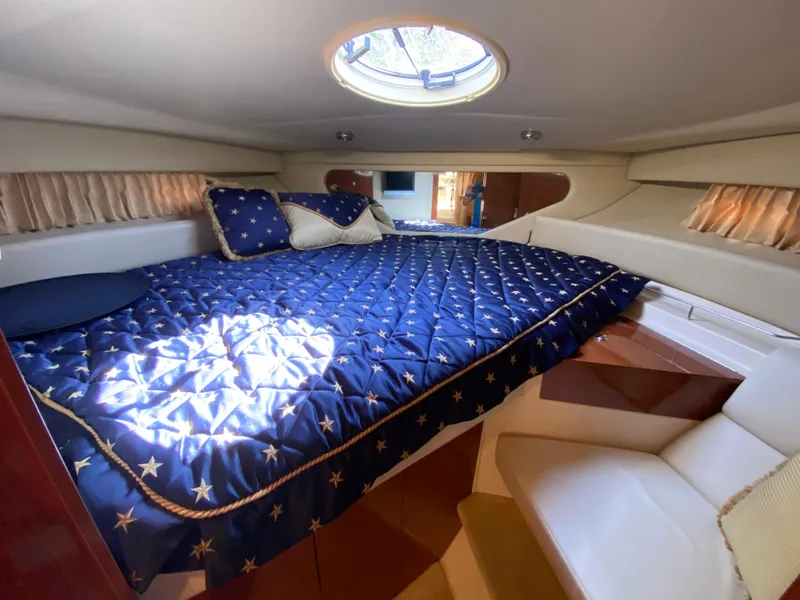 Slide: The Image of Luxurious cabin interior of 2006 Regal 3560 Commodore yacht with star-patterned bedding. - 2