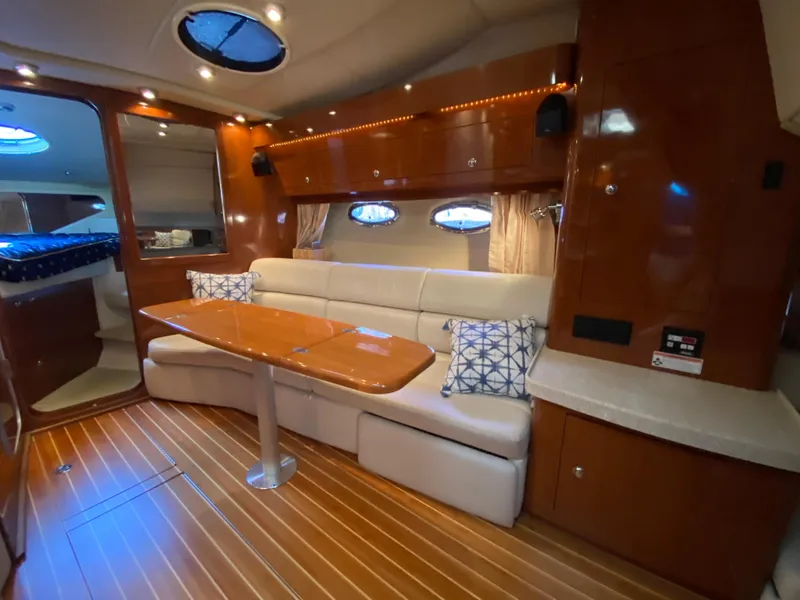 Slide: The Image of Luxurious 2006 Regal 3560 Commodore yacht interior with elegant wood finish and plush seating. - 21