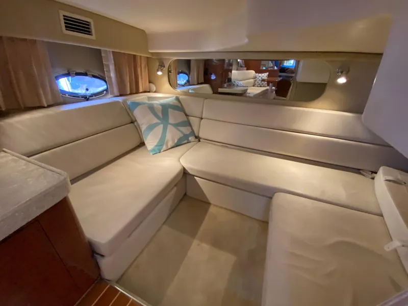 Slide: The Image of Interior of 2006 Regal 3560 Commodore yacht with beige seating and decorative pillow. - 26