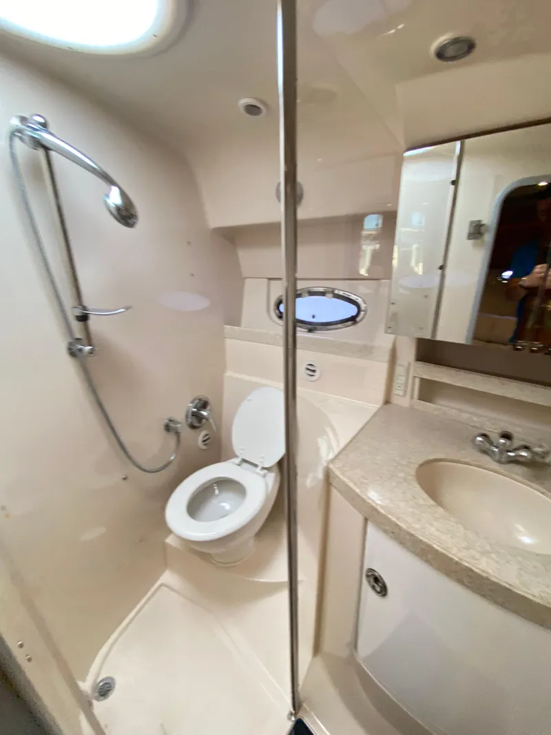 Slide: The Image of 2006 Regal 3560 Commodore yacht bathroom with shower, toilet, and sink. - 30