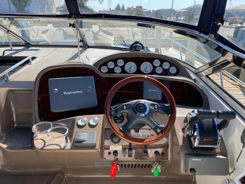 Slide: The Image of 2006 Regal 3560 Commodore boat dashboard with steering wheel and navigation instruments. - 4